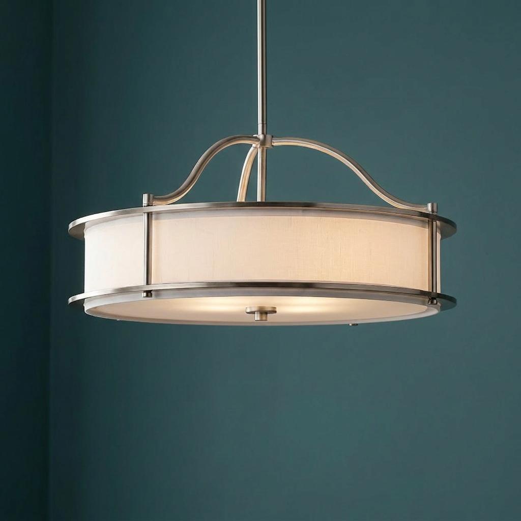Kichler Emory 4-light pewter semi-flush chandelier with a white drum shade against a dark teal wall.