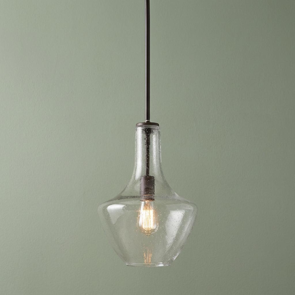 Kichler Everly bronze pendant light with a clear seeded glass bottle-shaped shade and Edison bulb.