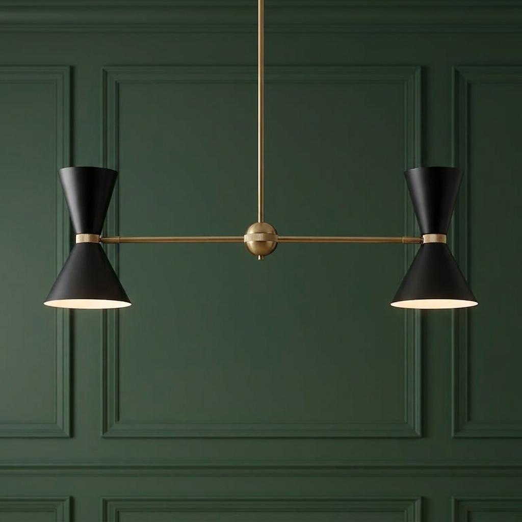 Modern linear chandelier with four black hourglass shades and brass finish on a dark green paneled wall.