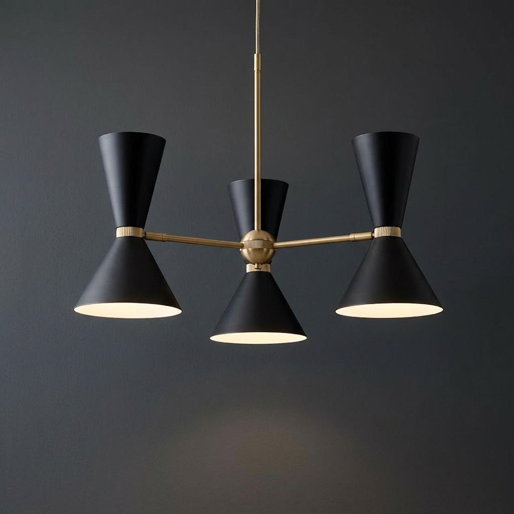 Kichler Phix three-arm chandelier with matte black hourglass shades and brass accents against a dark wall.