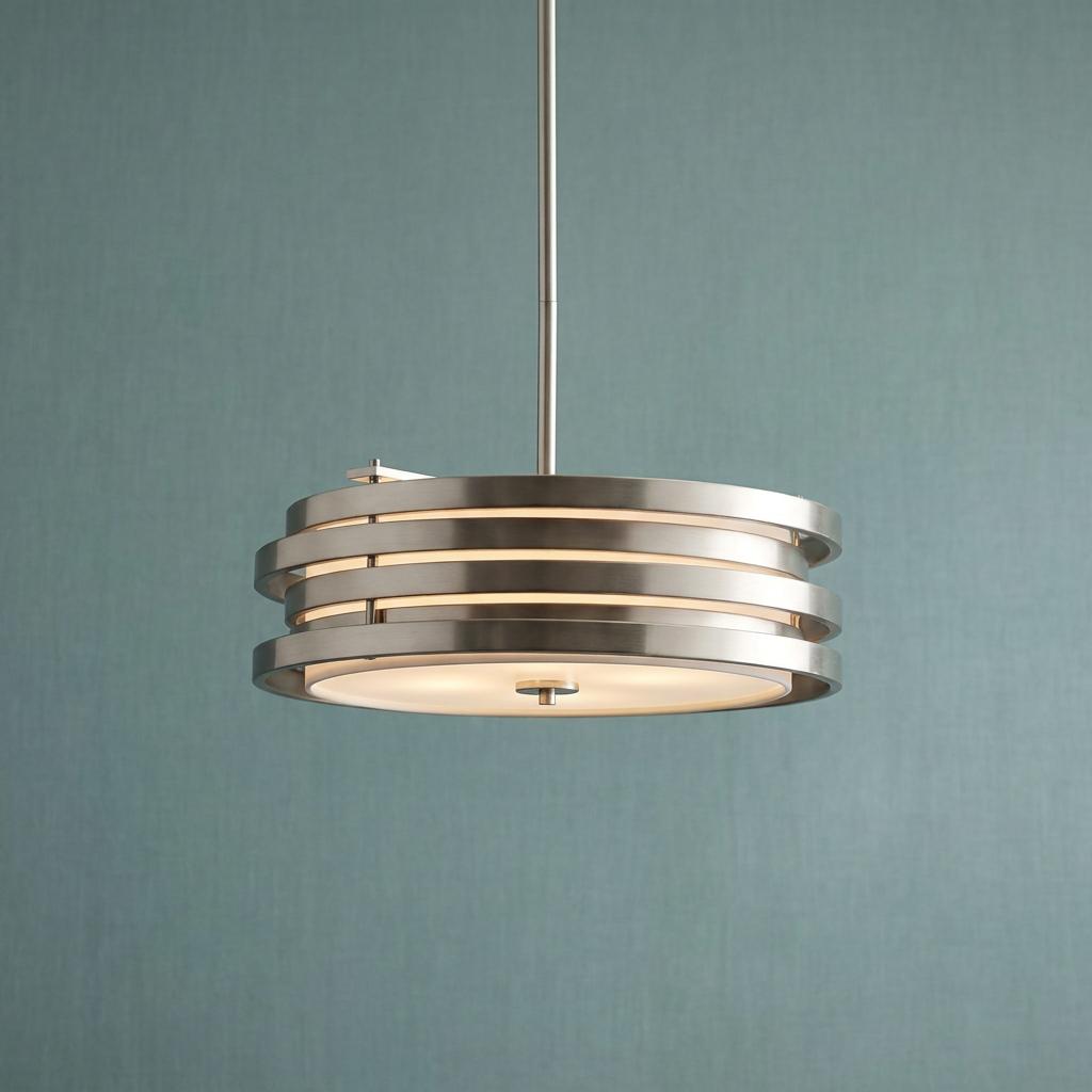 Kichler Roswell brushed nickel pendant light with concentric rings and frosted diffuser against a teal wall.