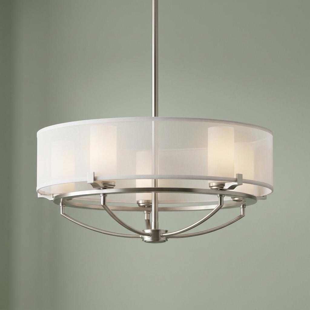 Kichler Saldana 5-light pendant with a classic pewter finish and white organza drum shade against a sage green wall.