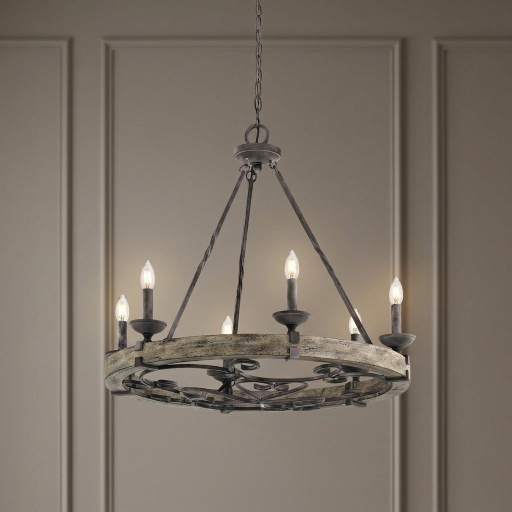 Kichler Taulbee 6-light zinc chandelier with a weathered wood ring and candle-style bulbs against a paneled wall.