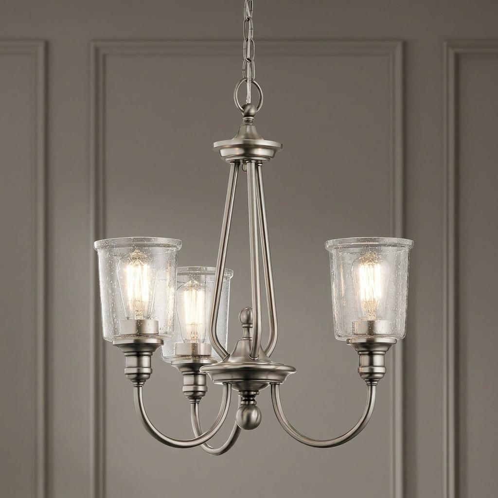 Kichler Waverly 3-light chandelier in classic pewter with seeded glass shades and lit filament bulbs.