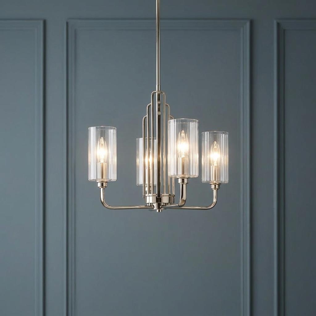 Polished nickel Kimrose 3-light chandelier with ribbed glass shades against a blue paneled wall.