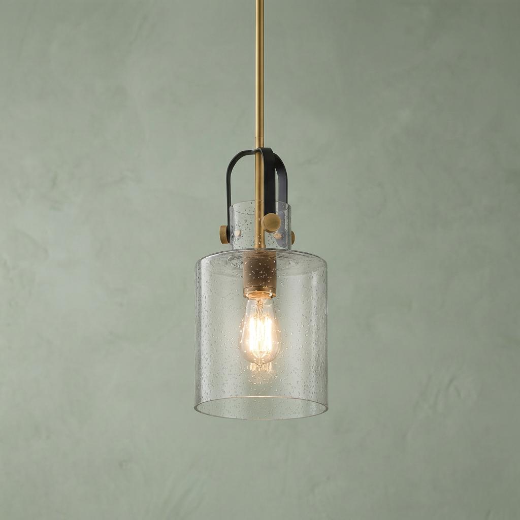 Kitner 1 Light Brass Ceiling Pendant Light with a seeded glass shade and black accents against a green wall.