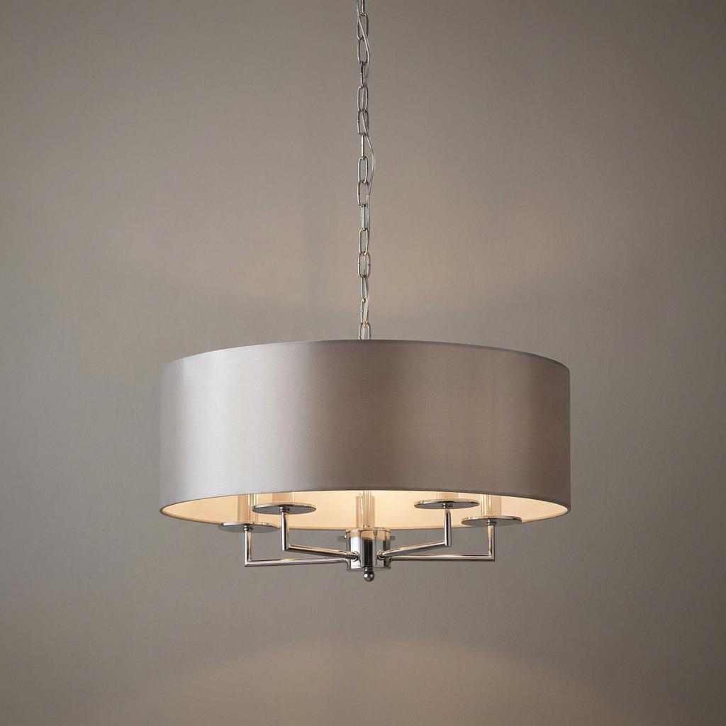 Modern three-light pendant fixture featuring a silver faux silk drum shade and polished silver hardware.