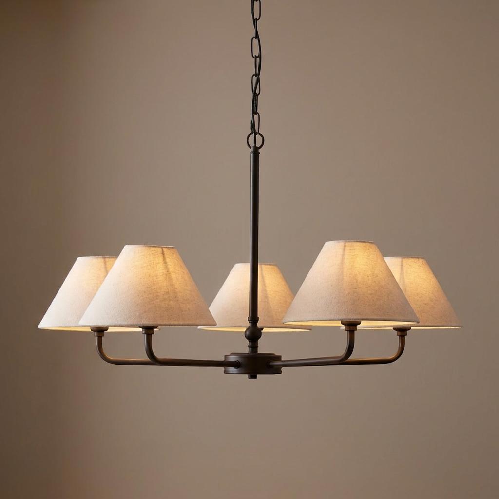 Black 5-light pendant fixture featuring conical linen shades and warm glowing illumination.