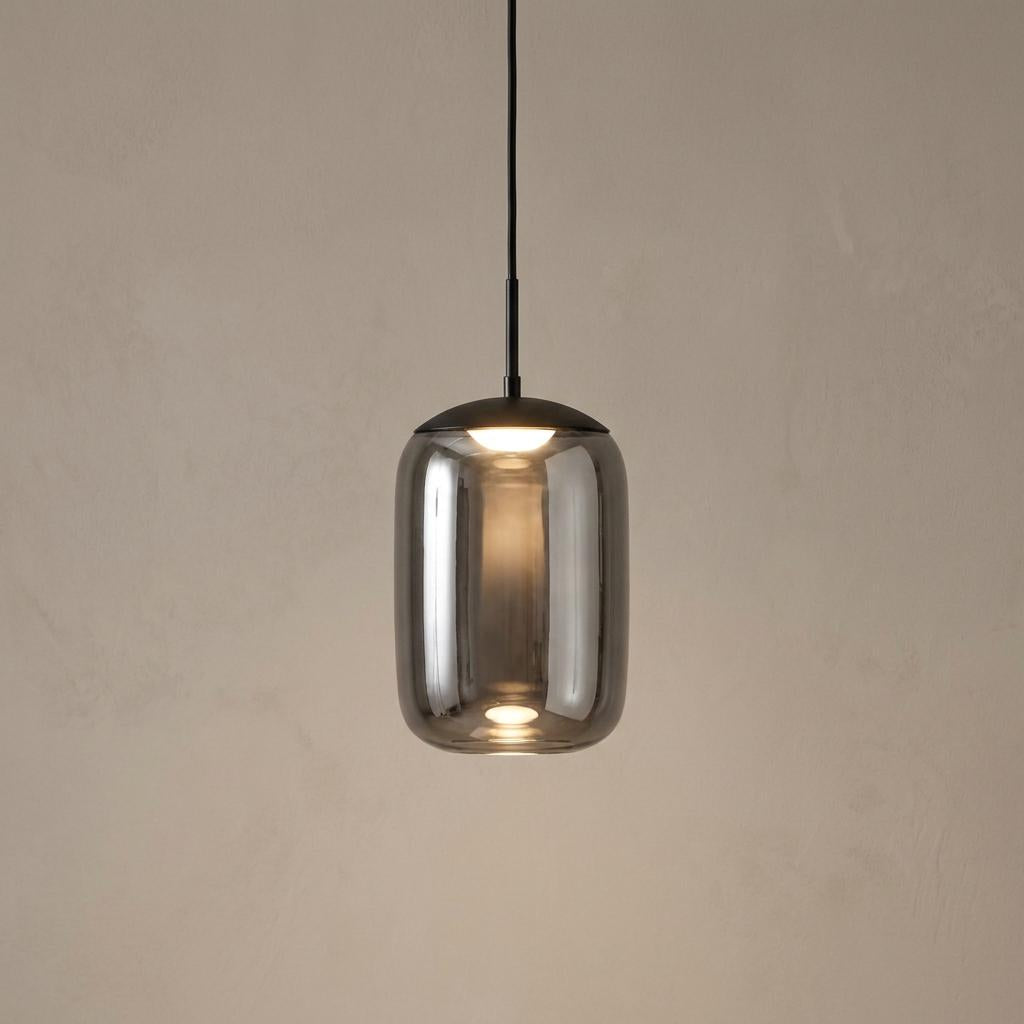 Lisbon 1 light black and smoked glass LED pendant with a capsule-shaped shade against a textured neutral wall.