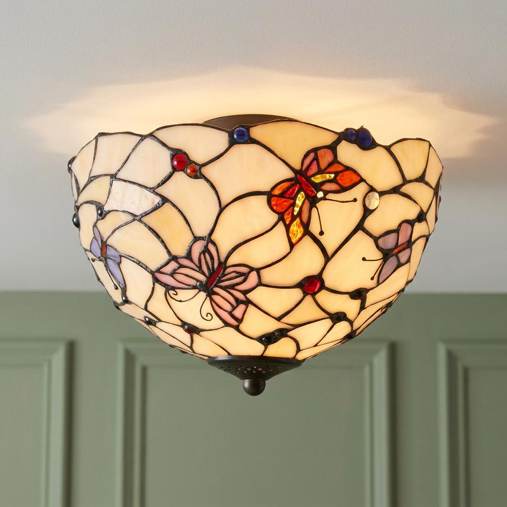 A Tiffany-style flush ceiling light with a butterfly-patterned stained glass shade mounted on a white ceiling.
