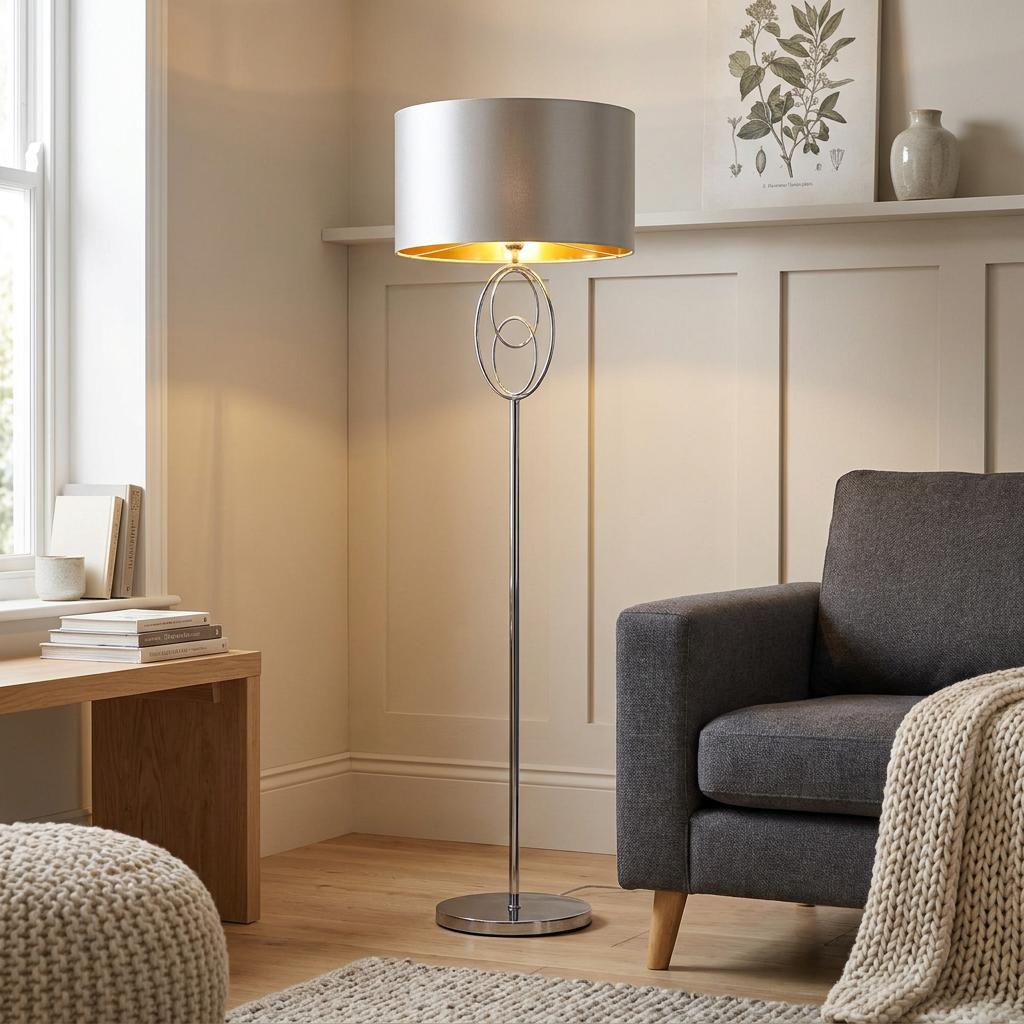 Modern chrome floor lamp with a circular loop design and silver drum shade in a cozy living room.