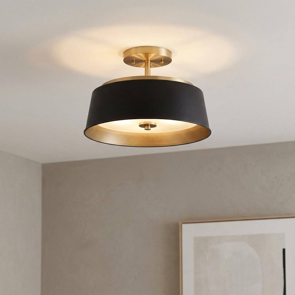 A black and brass drum-shaped ceiling light glowing in a modern interior setting.