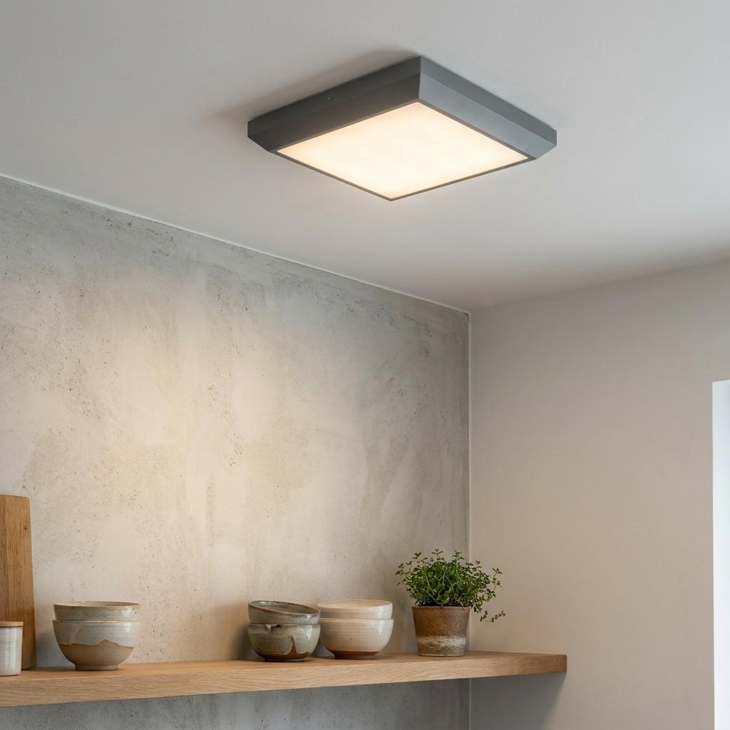 Square grey Lutec Helena LED ceiling light illuminates a modern interior with wooden shelves and a concrete wall.