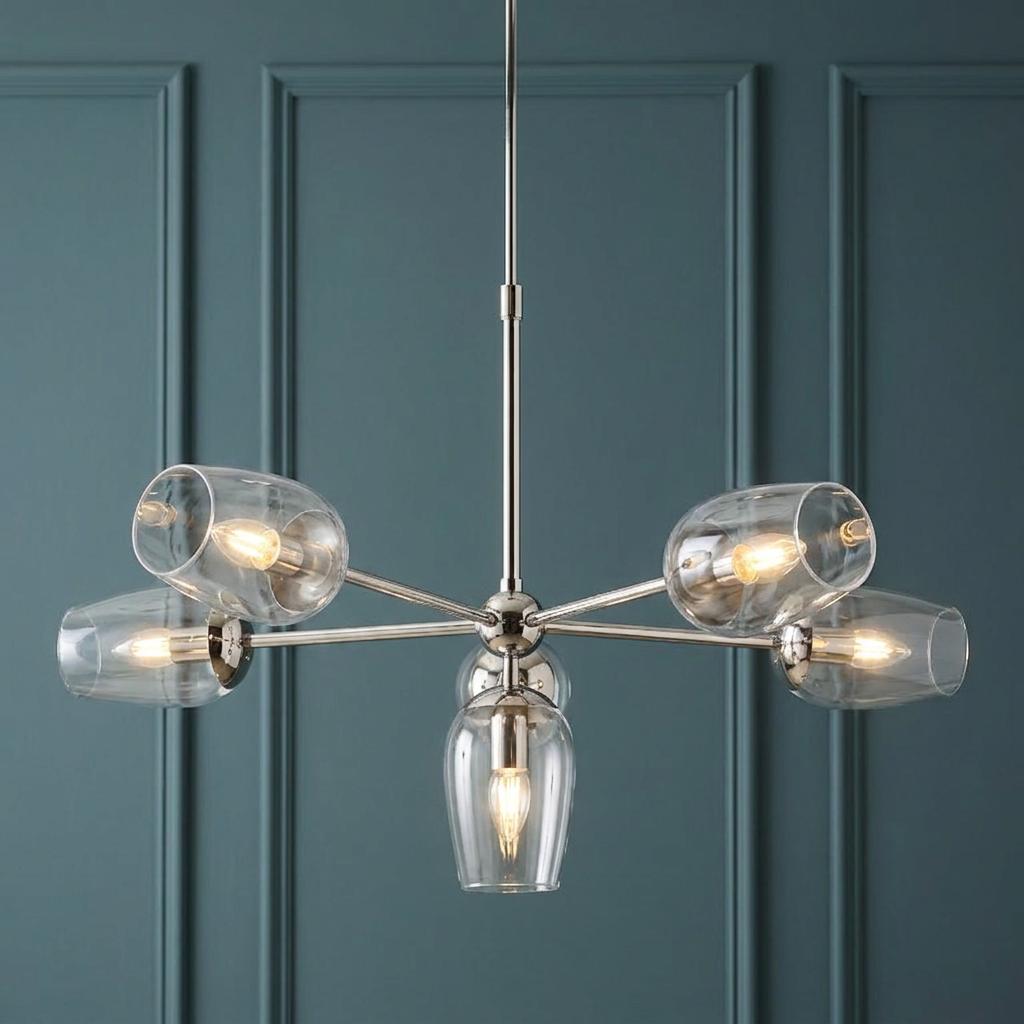 Maeve six-light polished nickel pendant with clear glass cup shades against a teal paneled wall.