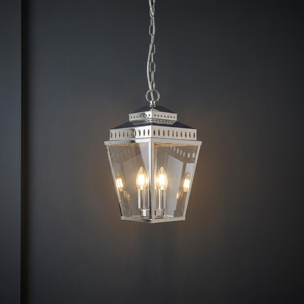 Mansion House 3 Light Chain Lantern in polished nickel with clear glass panels against a dark wall.