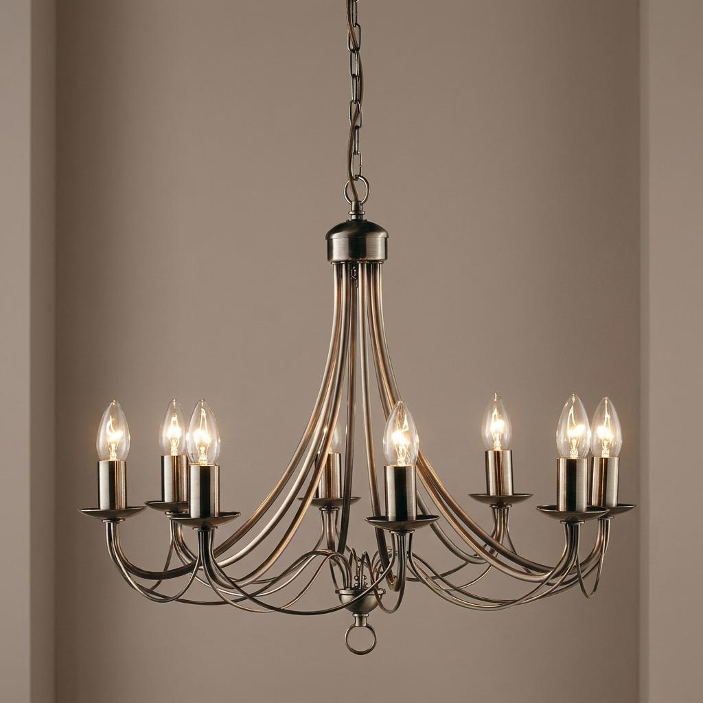 Maypole 8-light antique brass ceiling pendant with curved arms and candle-style bulbs against a neutral background.