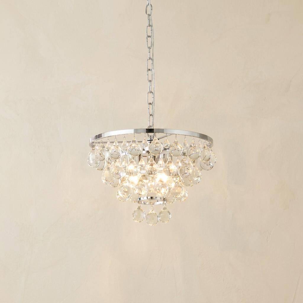 Michelle 4 light chrome ceiling pendant with tiered clear glass droplets, lit against a plain wall.
