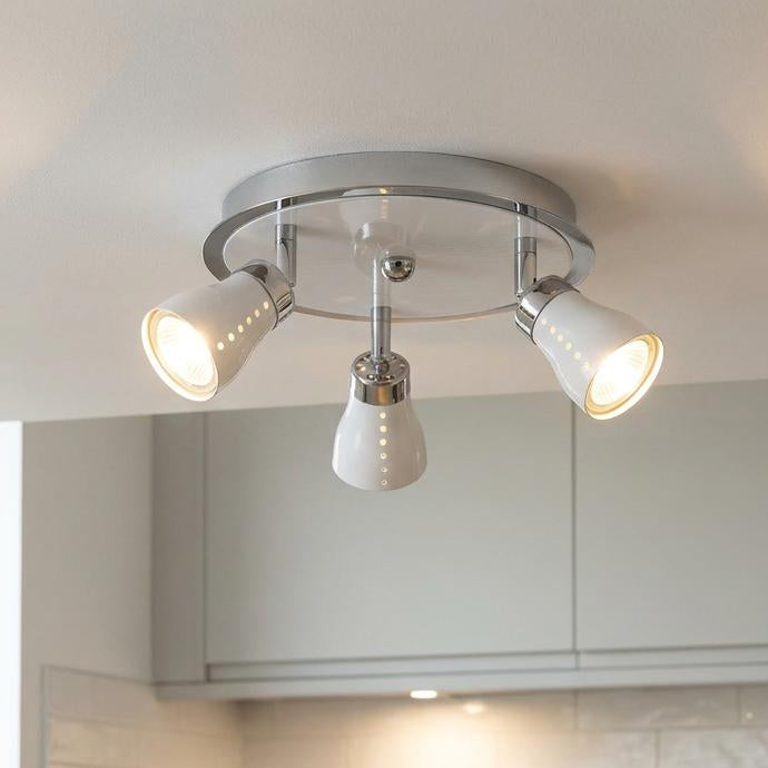 Milo 3-light white and chrome ceiling spotlight with adjustable heads illuminated in a kitchen.