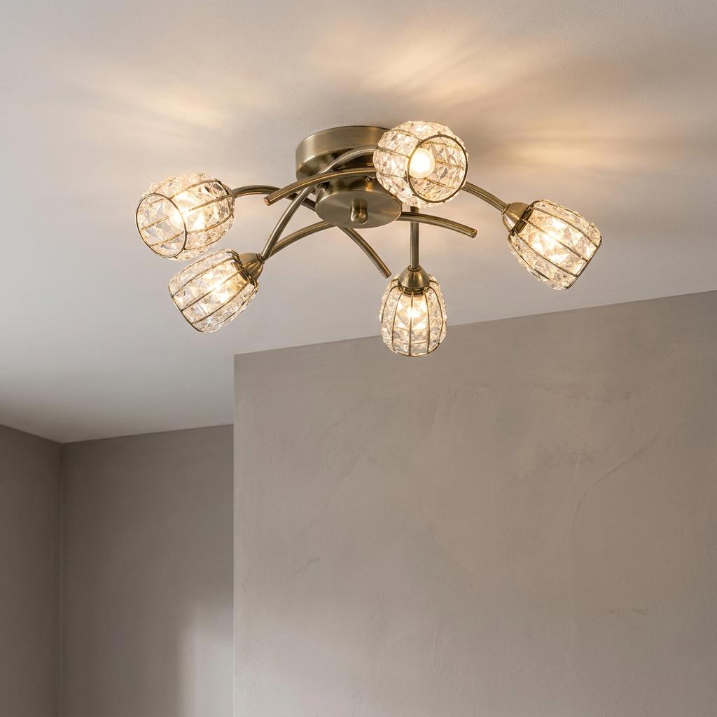 Naira 5-light antique brass flush ceiling fixture with crystal-studded cage shades on a white ceiling.