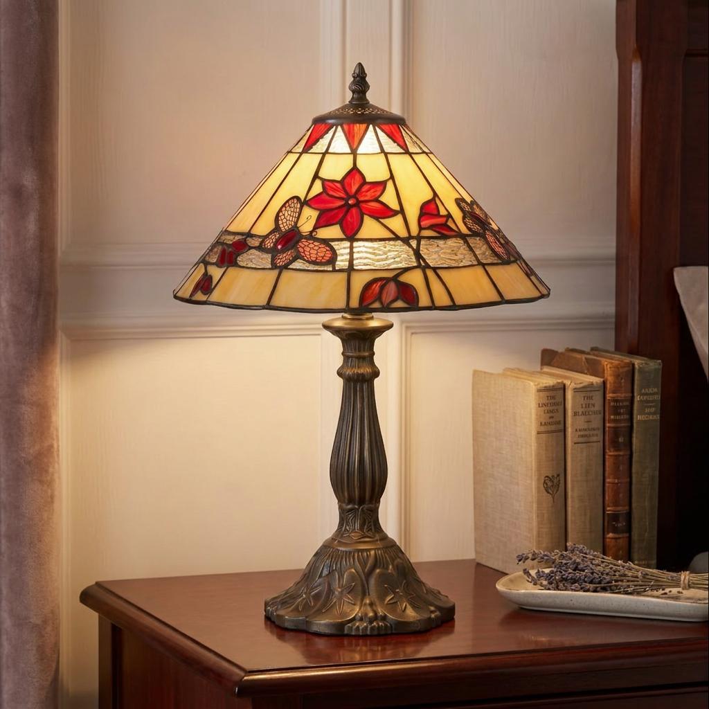 Tiffany-style table lamp with red butterfly and flower stained glass shade on a wooden bedside table.