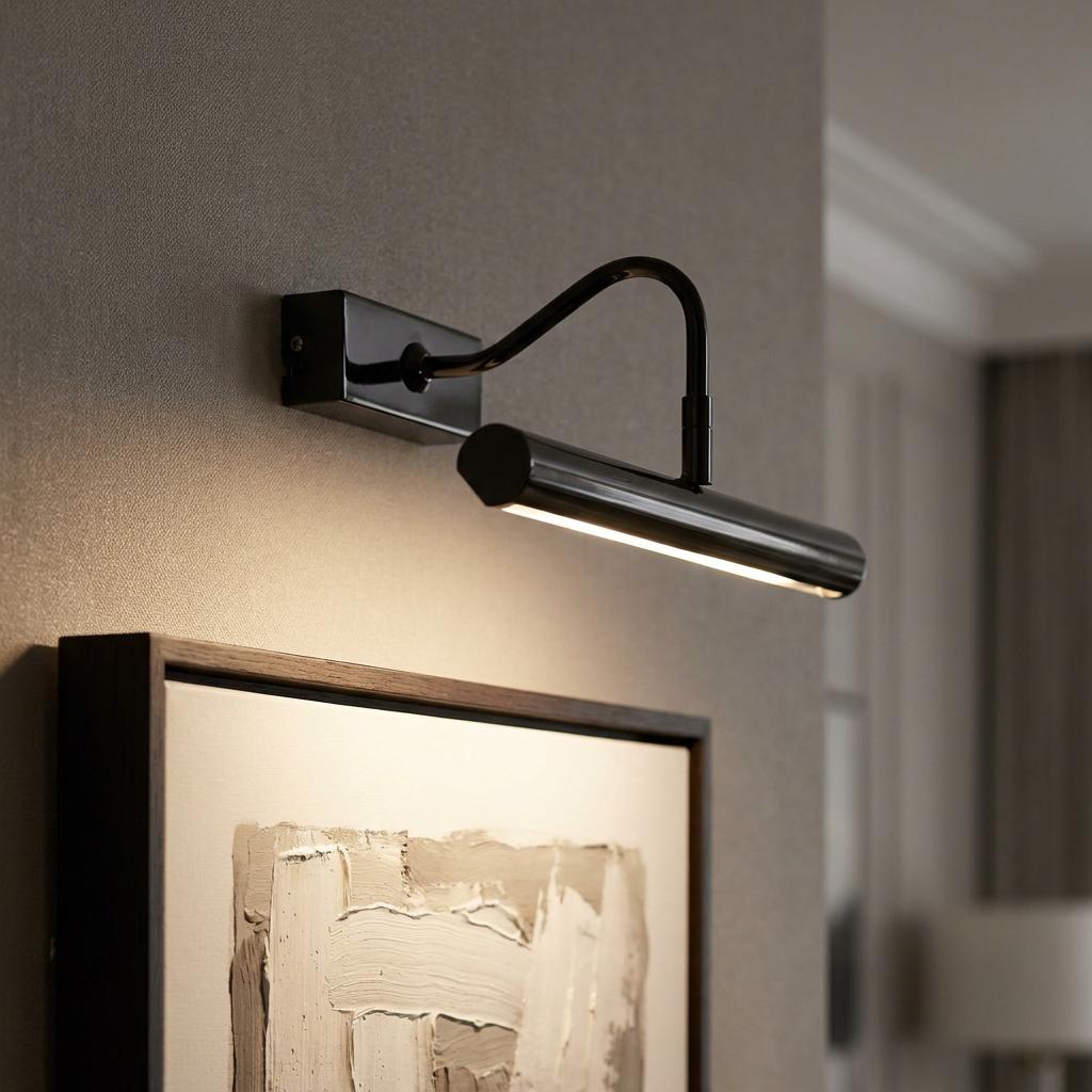 Sleek black chrome LED picture light illuminating abstract wall art in a modern interior setting.