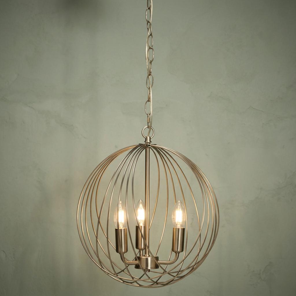 Antique chrome 3-light globe pendant with a spherical wire cage hanging from a chain against a textured wall.