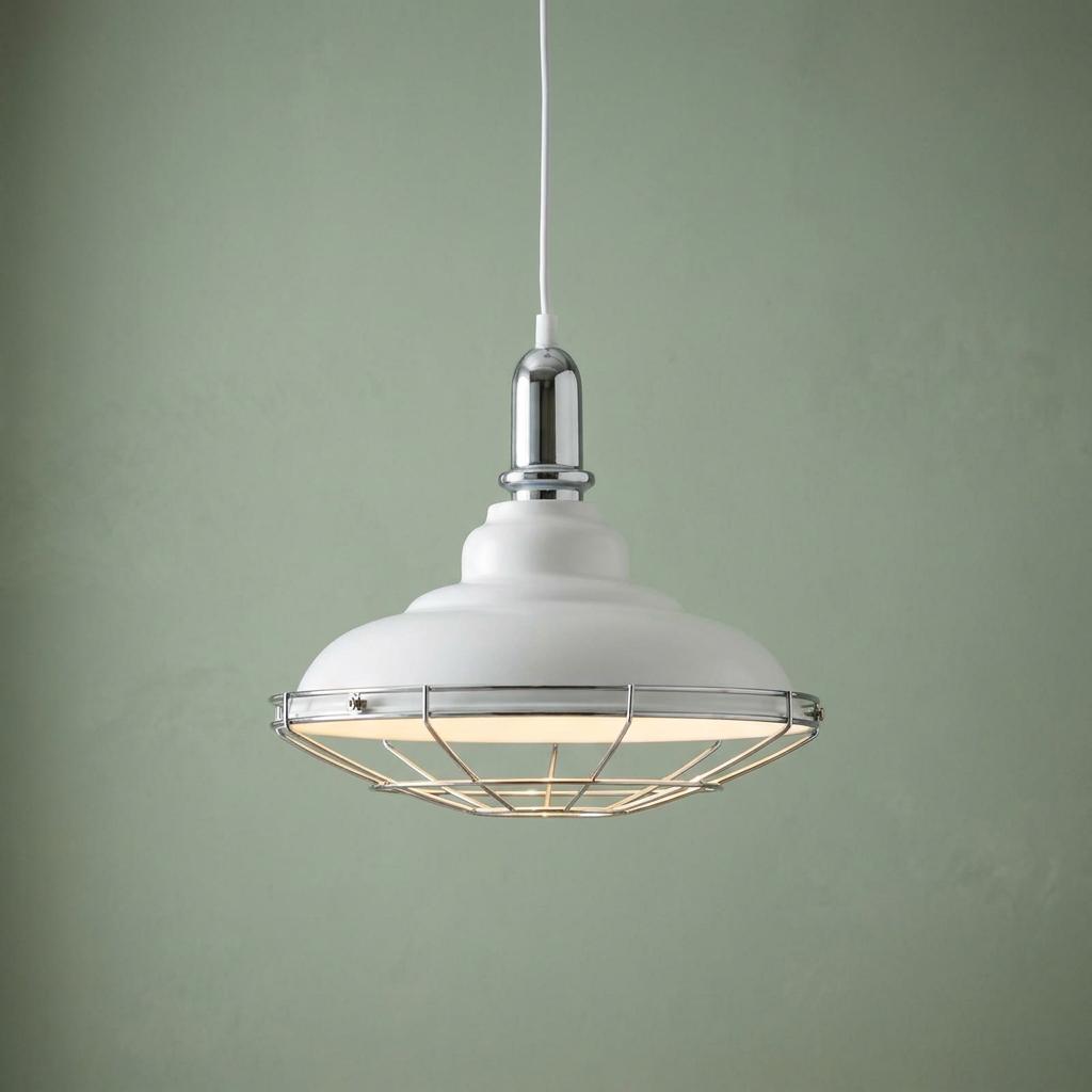 White domed ceiling pendant with chrome wire cage and hardware against a pale green wall.