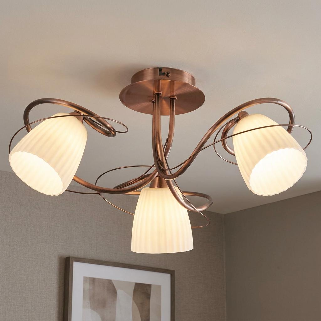 Antique copper semi-flush ceiling light with three frosted ribbed glass shades and decorative curved arms.