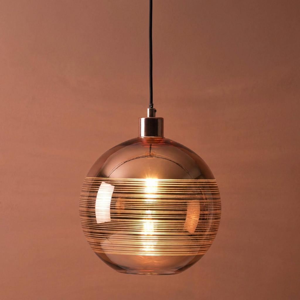 Oaks Lighting Lia copper plated globe pendant featuring horizontal etched lines and a warm internal glow.