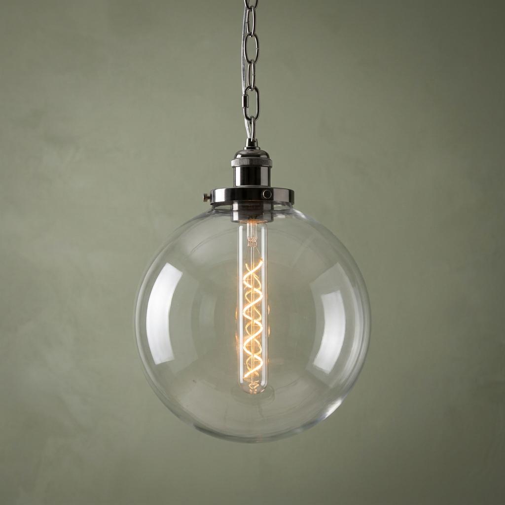 Black chrome and clear glass globe pendant light with a spiral filament bulb hanging from a silver chain.