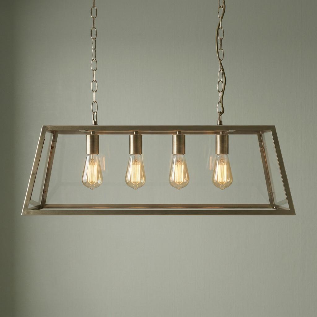 Four-light antique chrome ceiling pendant with a tapered glass frame and glowing filament bulbs.