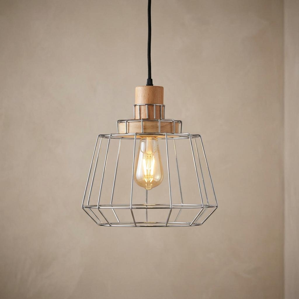 Chrome wire frame ceiling pendant with wooden details and an illuminated filament bulb against a beige wall.