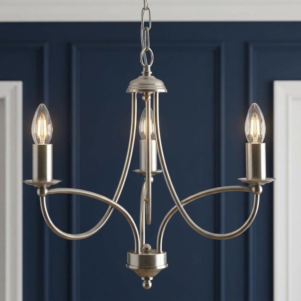 Antique chrome three-light chandelier with looping arms against a navy blue paneled wall.