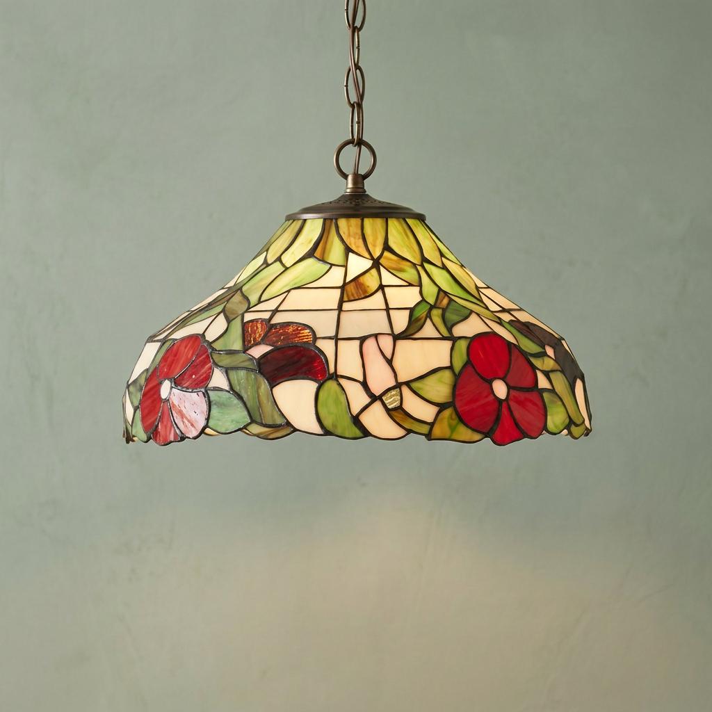 Tiffany-style pendant light with red peony stained glass shade hanging from a chain against a green wall.