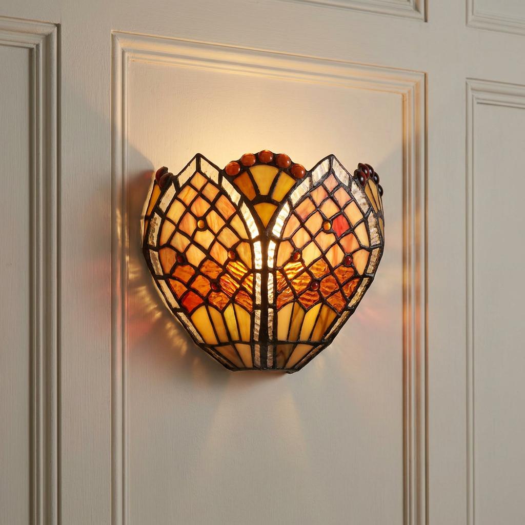 A Tiffany-style wall sconce with amber and orange glass in a lattice design, mounted on a paneled wall.