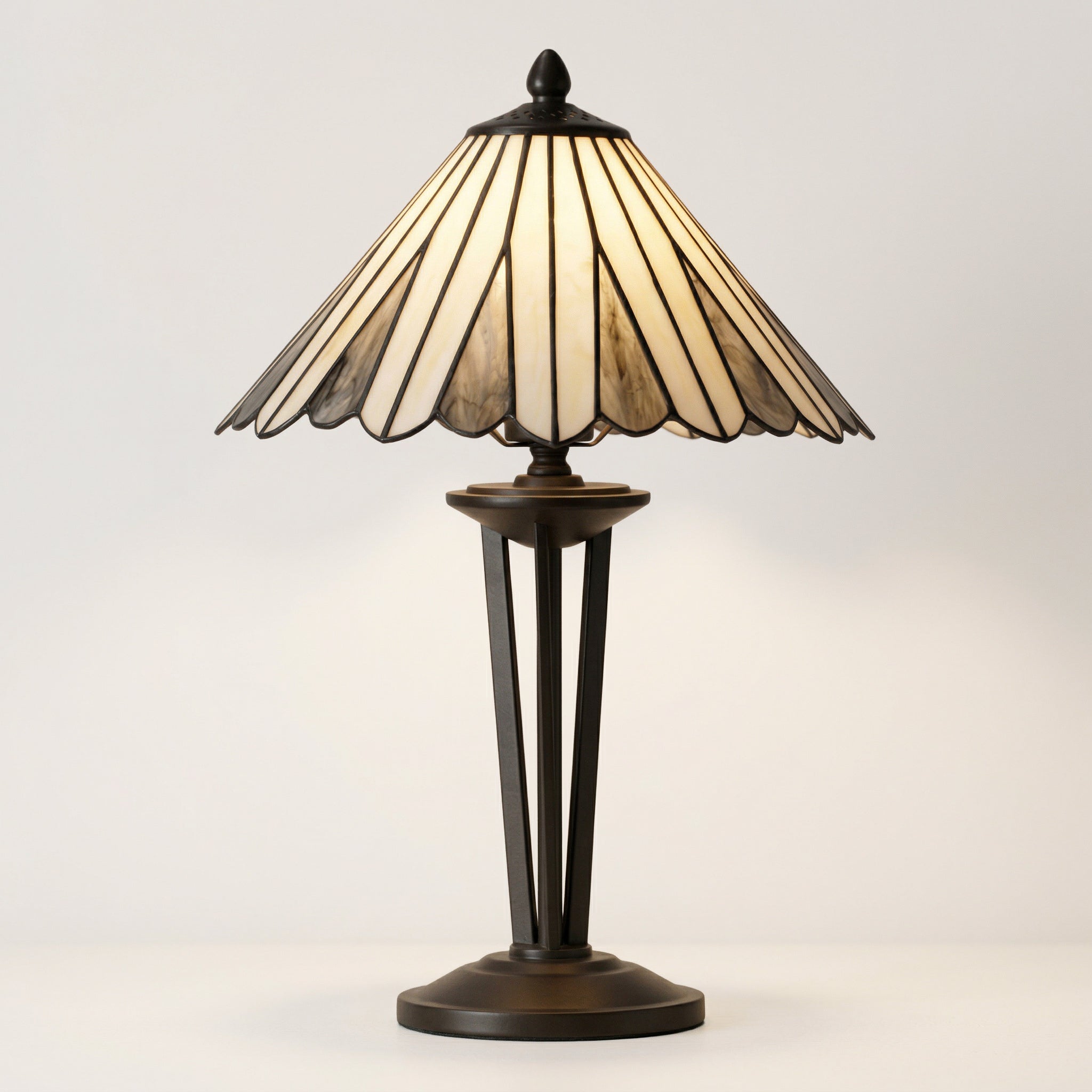 Decorative table lamp with a stained glass shade on a light background