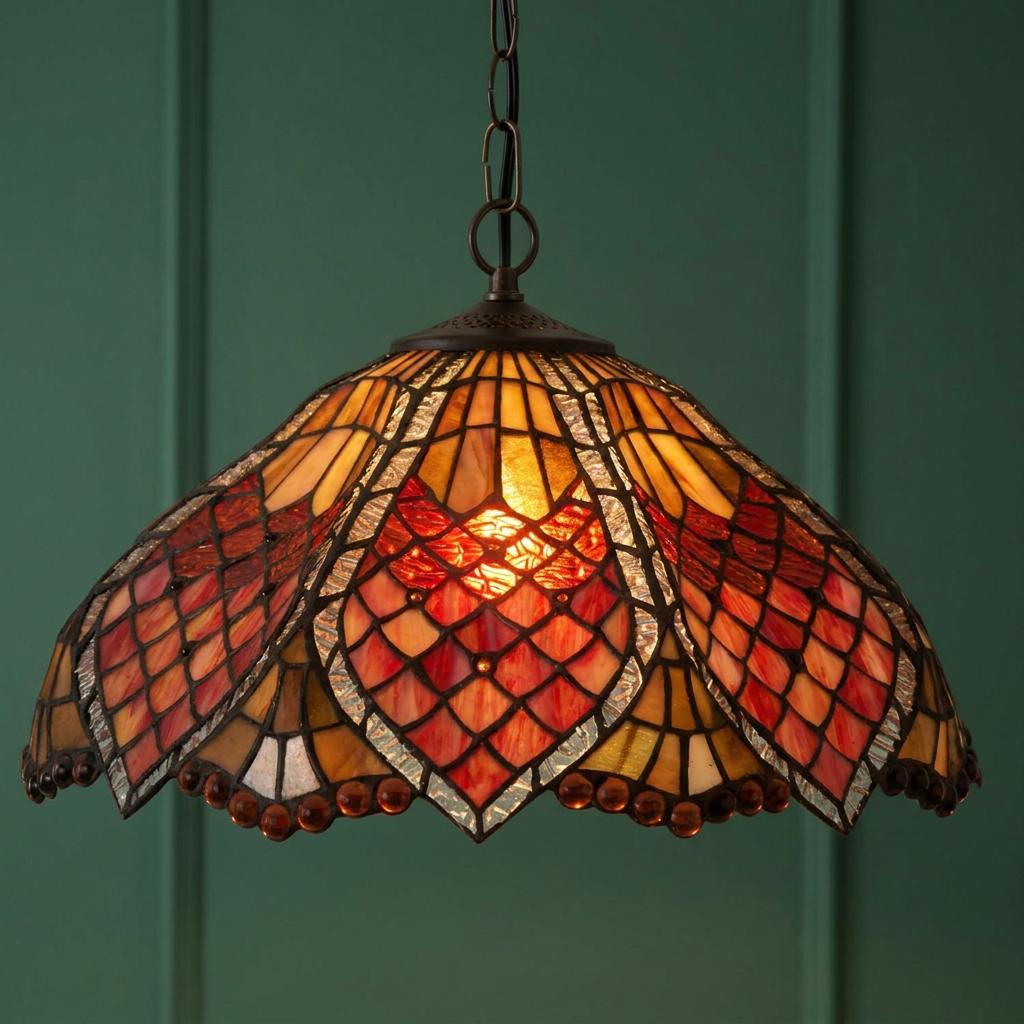 Orsino Large Tiffany Ceiling Light with a red and amber stained glass shade hanging against a green paneled wall.