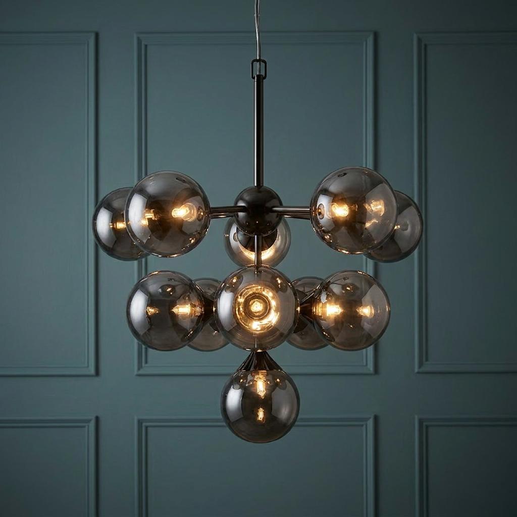 Oscar 11-light black pendant with smoked glass globe shades against a teal paneled wall.