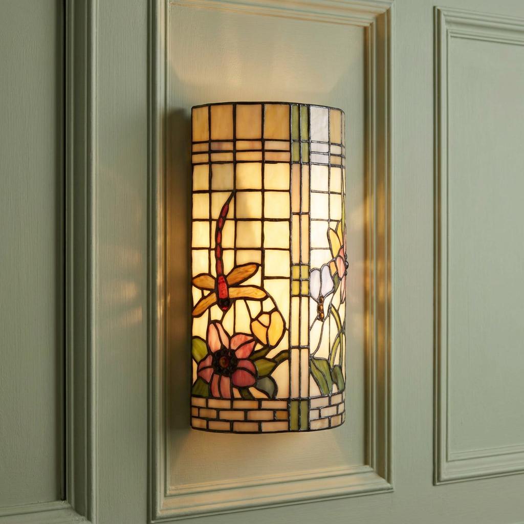 Pavot Tiffany wall light featuring a dragonfly and floral stained glass design on a paneled green wall.