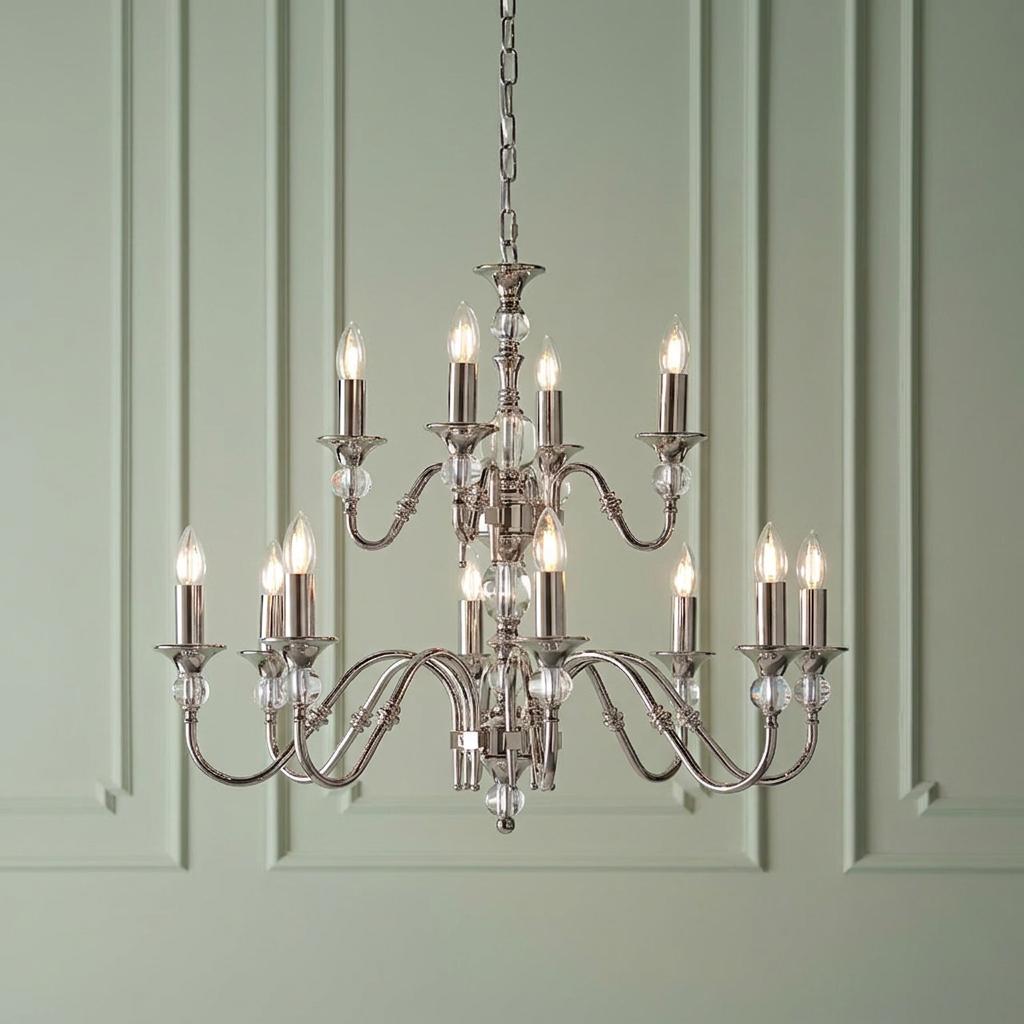 Twelve-light polished nickel chandelier with crystal accents hanging against a sage green paneled wall.