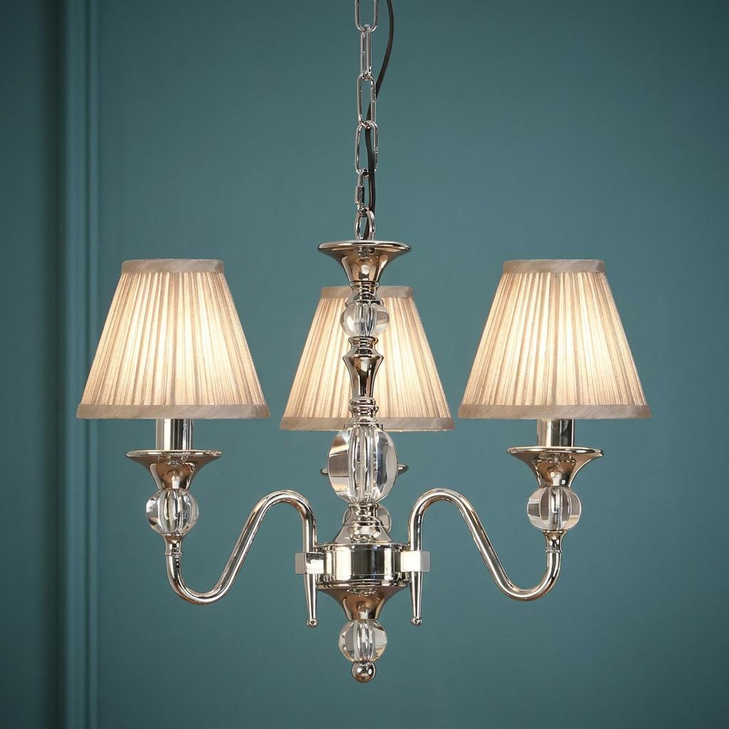 Polina 3-light polished nickel chandelier with pleated beige shades and crystal accents against a teal wall.