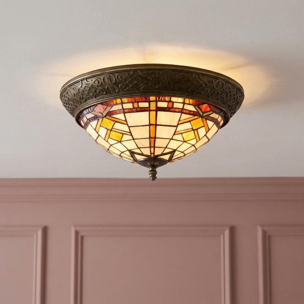 Tiffany-style flush mount ceiling light with a geometric beige and brown stained glass shade and ornate bronze frame.
