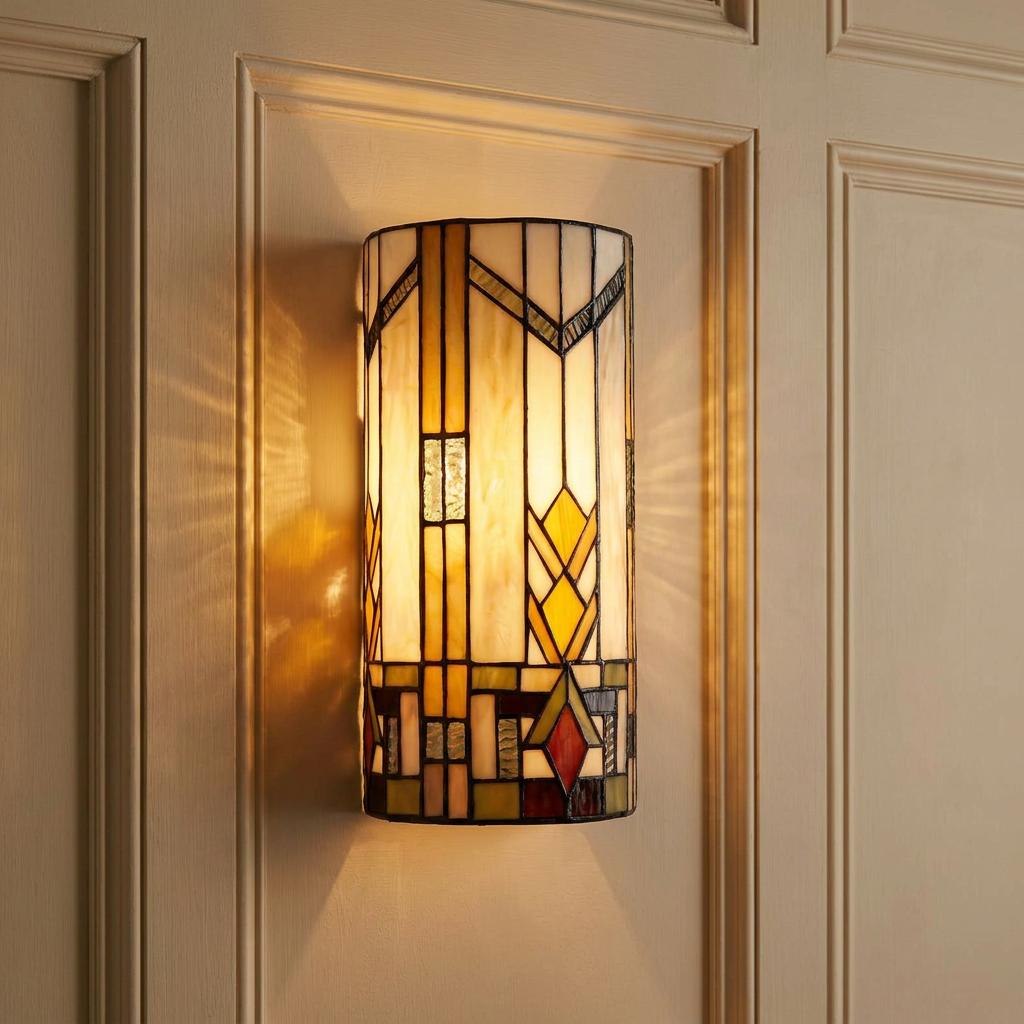Illuminated Prairie-style Tiffany wall light with a geometric stained glass pattern on a paneled wall.