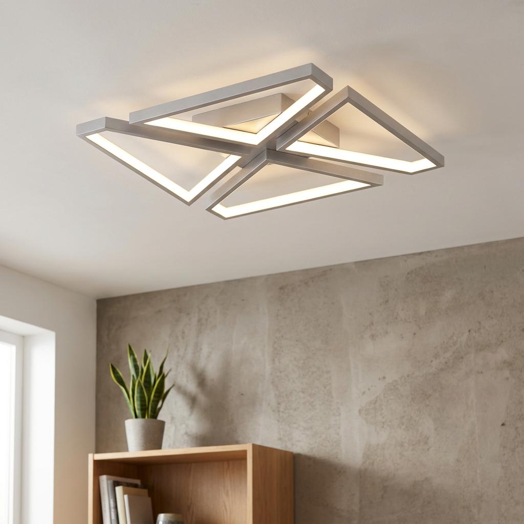 Modern satin silver Quatro flush ceiling light with four illuminated geometric triangular LED frames on a white ceiling.
