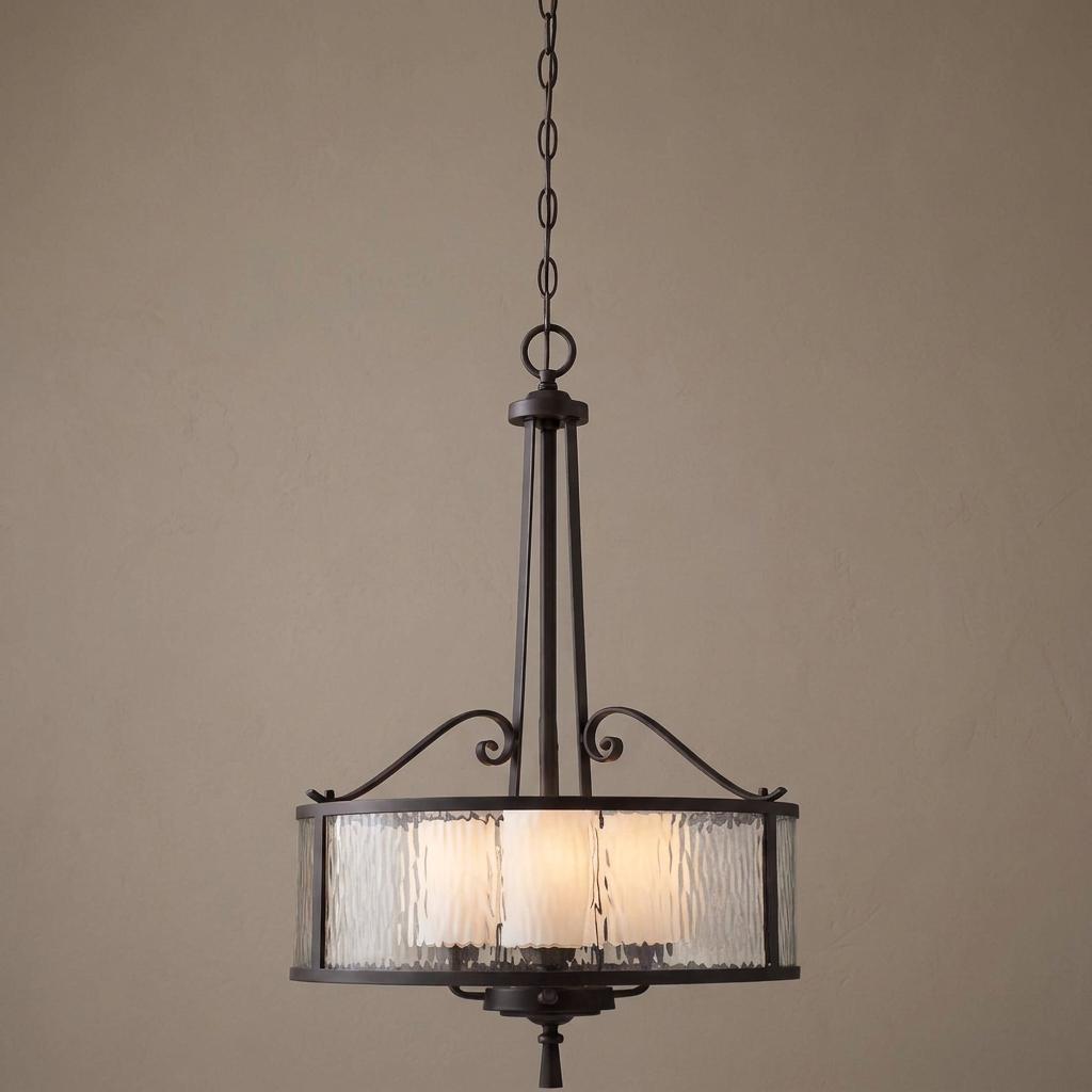 Three-light pendant with a dark cherry finish and a textured glass drum shade, featuring elegant scrolled accents.