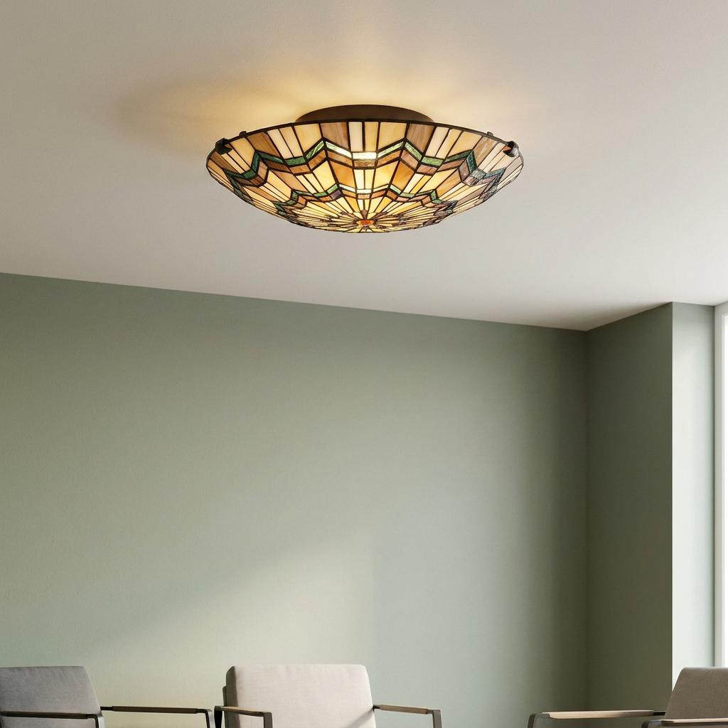 Glowing Quoizel Alcott Tiffany flush ceiling light with geometric stained glass in a sage green room.