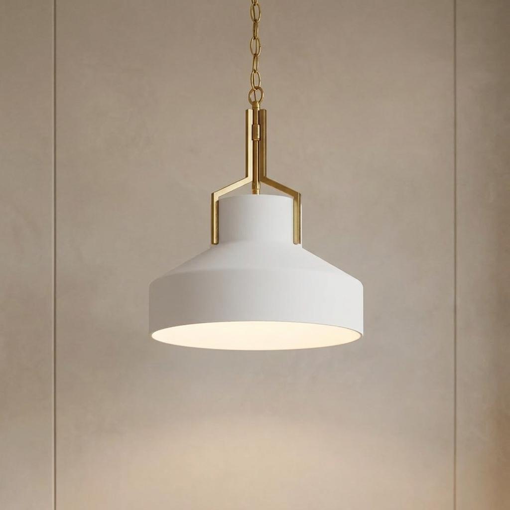 Aged brass and white opal glass pendant light hanging against a neutral beige wall.