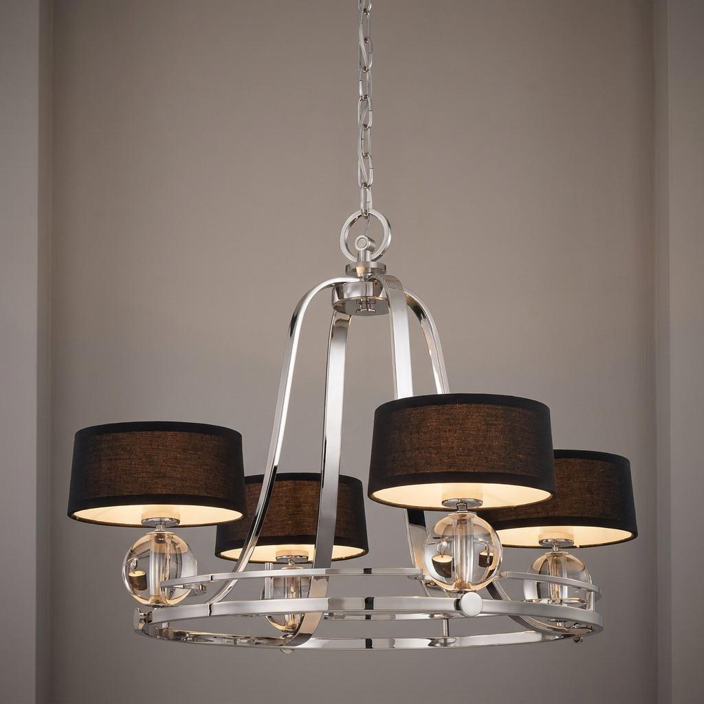 Quoizel Gotham 4-light silver chandelier with black drum shades and crystal spheres hanging against a neutral wall.