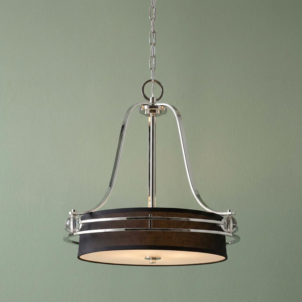 Quoizel Gotham 5 light imperial silver pendant ceiling light with a dark drum shade against a light green wall.