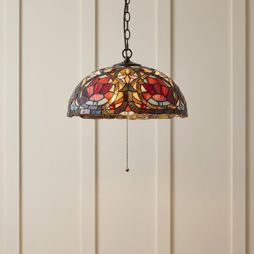 Larissa Tiffany ceiling pendant light with a stained glass floral shade and bronze chain hanging in front of a wall.